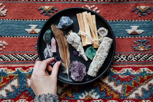 woman with sage and crystals ready for smudging